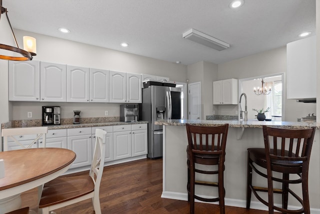 6443 Olde Ferry Lndg, Harrison, TN 37341 - kitchen with stainless steel fridge with ice dispenser, a chandelier, white cabinets, a kitchen breakfast bar, and recessed lighting