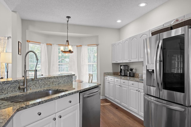 6443 Olde Ferry Lndg, Harrison, TN 37341 - kitchen featuring appliances with stainless steel finishes, a sink, a textured ceiling, dark wood-type flooring, and white cabinetry