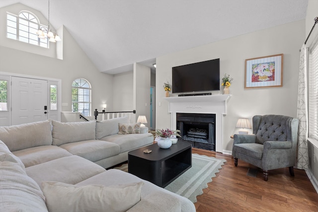 6443 Olde Ferry Lndg, Harrison, TN 37341 - living room with wood finished floors, high vaulted ceiling, a fireplace, and baseboards