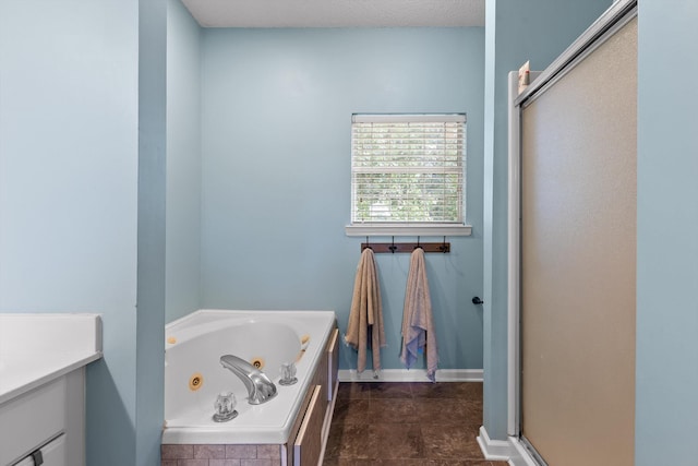 6443 Olde Ferry Lndg, Harrison, TN 37341 - full bathroom featuring a jetted tub, a stall shower, vanity, and baseboards