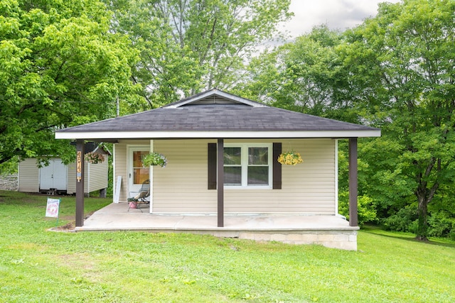 4813 Blue Bell Ave, Ooltewah, TN 37363 - view of front of property featuring a shingled roof, a front yard, covered porch, and view of wooded area