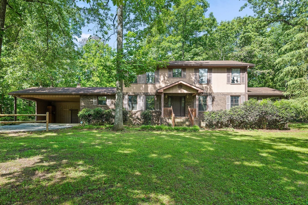 2400 Cedar Creek Dr, Chattanooga, TN 37421 - view of front facade featuring an attached carport, a front lawn, and brick siding