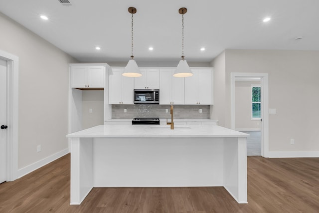2732 Butlers Green Cir Unit 27, Chattanooga, TN 37421 - kitchen featuring appliances with stainless steel finishes, wood finished floors, decorative backsplash, baseboards, and white cabinetry