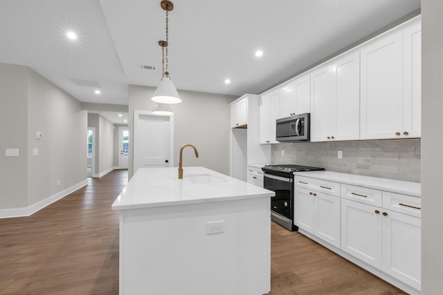 2732 Butlers Green Cir Unit 27, Chattanooga, TN 37421 - kitchen featuring gas range oven, a sink, stainless steel microwave, wood finished floors, and recessed lighting