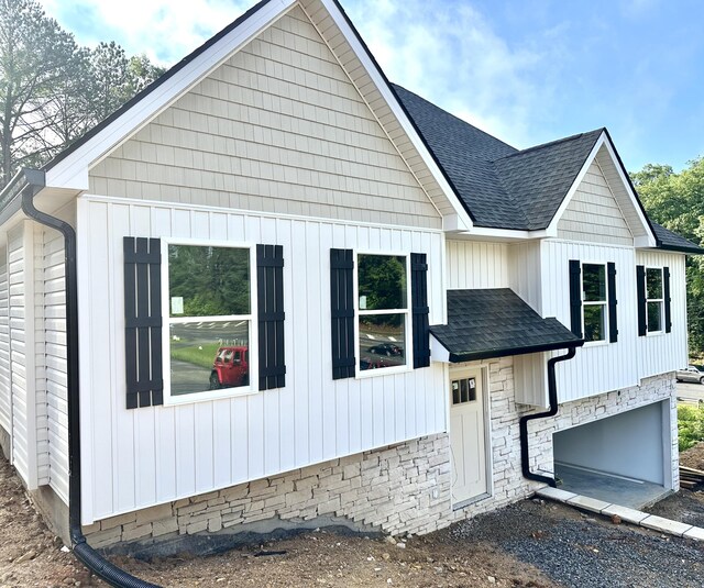 48 W Highland Dr Unit 25, Ringgold, GA 30736 - view of front facade featuring a shingled roof, stone siding, and a garage