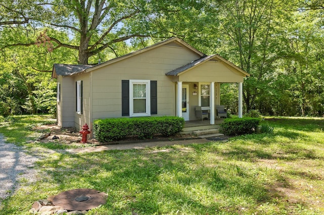 8504 Walnut Rd, Hixson, TN 37343 - bungalow-style house featuring covered porch and a front lawn