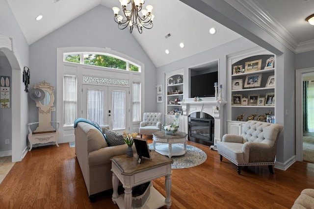 604 Lenna Ln, Dalton, GA 30720 - living room with a chandelier, a glass covered fireplace, wood finished floors, arched walkways, and built in features