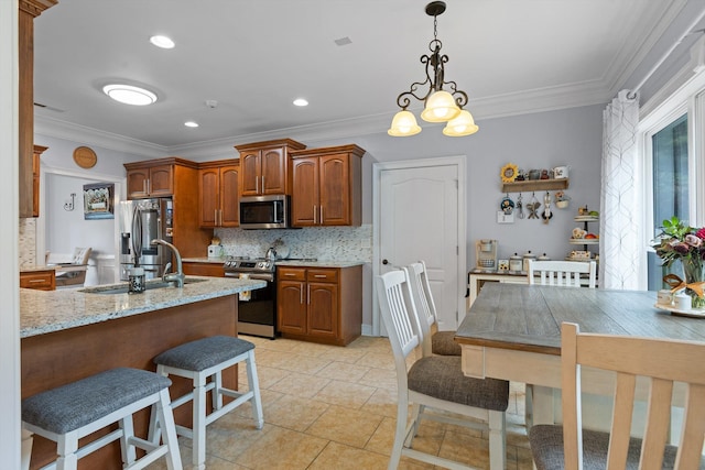 604 Lenna Ln, Dalton, GA 30720 - kitchen with appliances with stainless steel finishes, decorative backsplash, a sink, a breakfast bar area, and crown molding