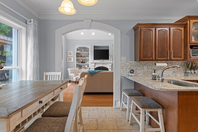 604 Lenna Ln, Dalton, GA 30720 - dining space featuring a fireplace, crown molding, and light tile patterned flooring