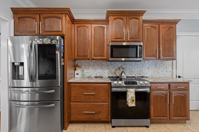 604 Lenna Ln, Dalton, GA 30720 - kitchen with stainless steel appliances, crown molding, light stone countertops, light tile patterned floors, and backsplash