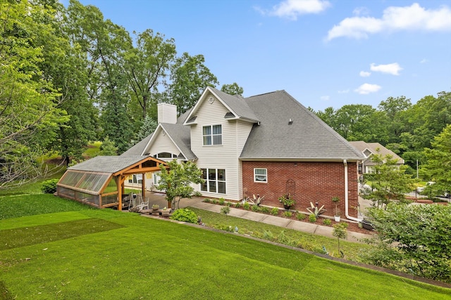 604 Lenna Ln, Dalton, GA 30720 - back of house featuring an exterior structure, brick siding, a yard, and a chimney