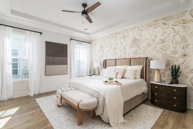 1522 Little Sorrel Rd Unit 034, Hixson, TN 37343 - bedroom with a tray ceiling, wood finished floors, wallpapered walls, baseboards, and a ceiling fan