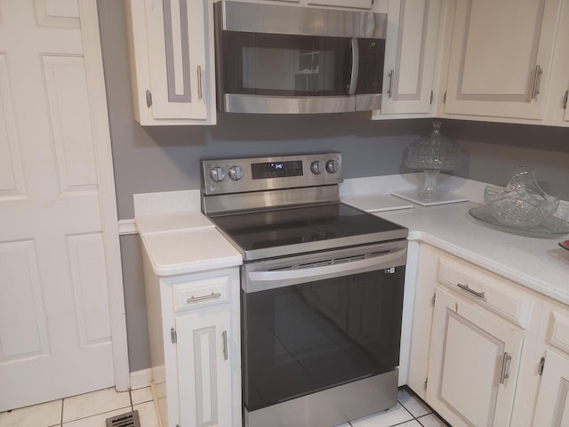 3415 Bennett Rd, Chattanooga, TN 37412 - kitchen with appliances with stainless steel finishes, light countertops, and light tile patterned floors
