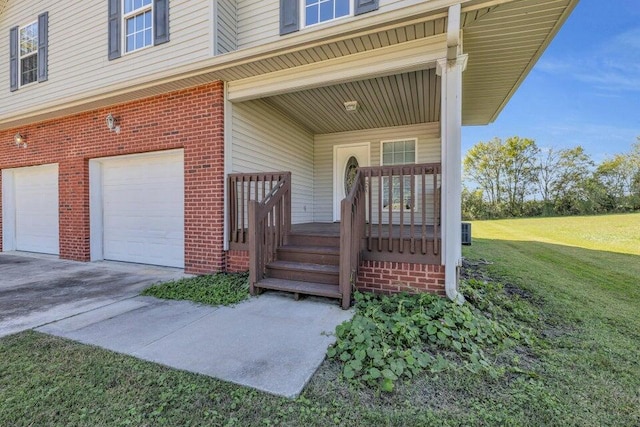 1770 Thrasher Pike, Hixson, TN 37343 - doorway to property featuring an attached garage, brick siding, a lawn, concrete driveway, and covered porch