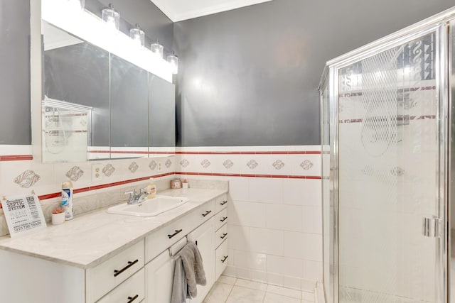1615 Wilson Rd, Rossville, GA 30741 - bathroom featuring vanity, a stall shower, wainscoting, tile patterned floors, and tile walls