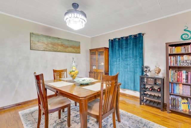 1615 Wilson Rd, Rossville, GA 30741 - dining room featuring crown molding, wood finished floors, a chandelier, and baseboards