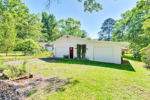 1615 Wilson Rd, Rossville, GA 30741 - view of front of house featuring a detached garage, a vegetable garden, and an outdoor structure
