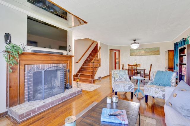 1615 Wilson Rd, Rossville, GA 30741 - living area with stairs, wood finished floors, ornamental molding, and a brick fireplace