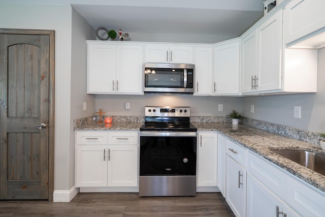 595 New Union Cir, Dayton, TN 37321 - kitchen featuring appliances with stainless steel finishes, white cabinets, dark wood-type flooring, and light stone counters