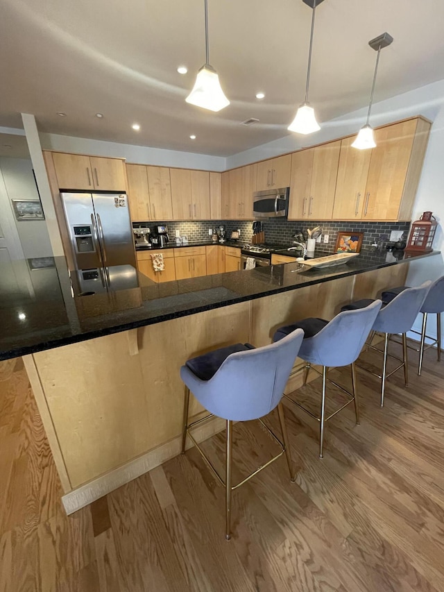 4 Cherokee Blvd Unit 306, Chattanooga, TN 37405 - kitchen with appliances with stainless steel finishes, light brown cabinets, wood finished floors, tasteful backsplash, and recessed lighting