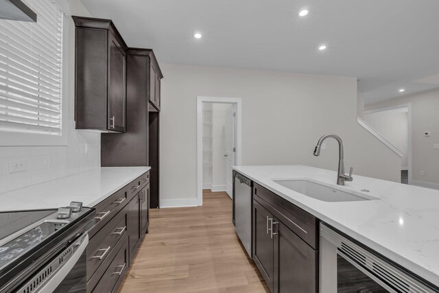 2592 Butlers Green Cir Unit 9, Chattanooga, TN 37421 - kitchen featuring appliances with stainless steel finishes, a sink, light wood-style floors, dark brown cabinetry, and light stone counters