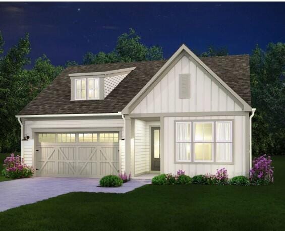 2592 Butlers Green Cir Unit 9, Chattanooga, TN 37421 - view of front of house featuring board and batten siding, roof with shingles, concrete driveway, a yard, and a garage