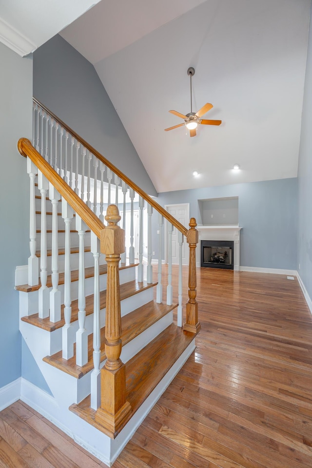7762 Lynnle Way, Hixson, TN 37343 - staircase with ceiling fan, lofted ceiling, hardwood / wood-style flooring, a fireplace, and recessed lighting