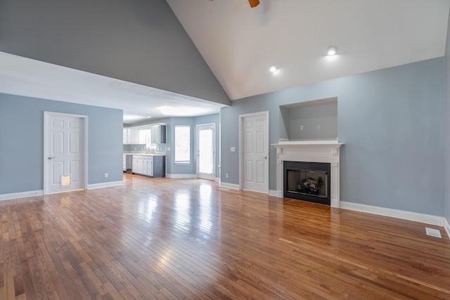 7762 Lynnle Way, Hixson, TN 37343 - unfurnished living room featuring a fireplace, wood-type flooring, high vaulted ceiling, and a ceiling fan