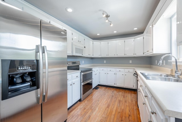 7762 Lynnle Way, Hixson, TN 37343 - kitchen featuring appliances with stainless steel finishes, light wood-style flooring, white cabinetry, light countertops, and recessed lighting