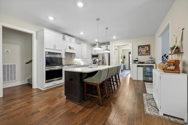1590 Buttonwood Unit 20, Chattanooga, TN 37421 - kitchen featuring a sink, appliances with stainless steel finishes, beverage cooler, a kitchen bar, and dark wood-style flooring