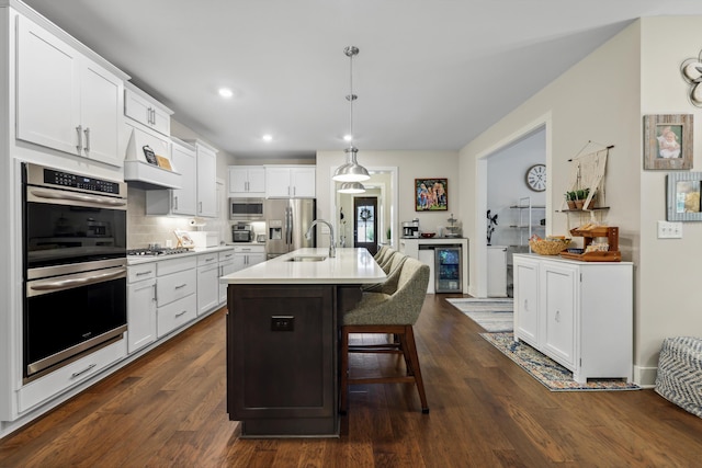 1590 Buttonwood Unit 20, Chattanooga, TN 37421 - kitchen with stainless steel appliances, a sink, white cabinetry, light countertops, and a breakfast bar area