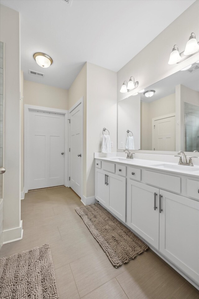1590 Buttonwood Unit 20, Chattanooga, TN 37421 - bathroom featuring double vanity, baseboards, and a shower