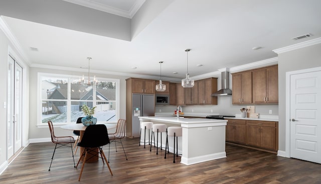 316 Fox Gap Ln Unit 316, Hixson, TN 37343 - kitchen featuring wall chimney exhaust hood, built in appliances, brown cabinetry, dark wood-type flooring, and a center island with sink