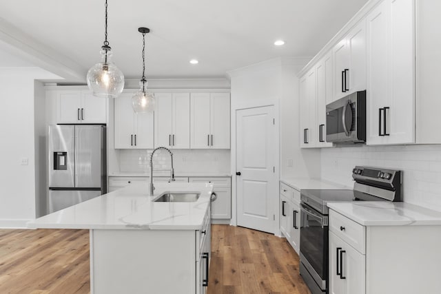 3563 Knollwood Hill Dr, Chattanooga, TN 37415 - kitchen featuring appliances with stainless steel finishes, a sink, backsplash, decorative light fixtures, and light wood-type flooring