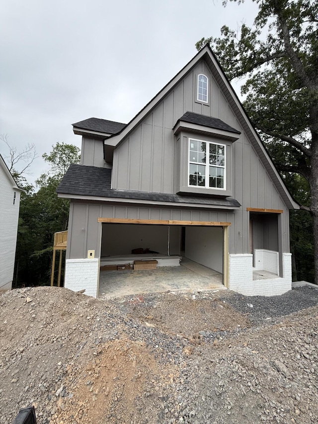 3563 Knollwood Hill Dr, Chattanooga, TN 37415 - view of front of property featuring board and batten siding, a shingled roof, brick siding, and driveway