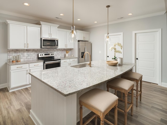 8868 Knolling Loop Unit 36, Ooltewah, TN 37363 - kitchen with appliances with stainless steel finishes, a sink, light wood-style floors, white cabinets, and recessed lighting