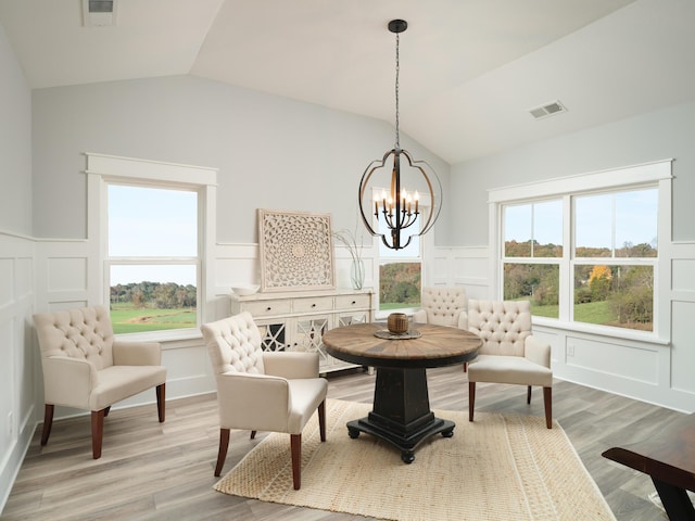 8868 Knolling Loop Unit 36, Ooltewah, TN 37363 - dining room featuring a decorative wall, vaulted ceiling, a chandelier, wainscoting, and light wood finished floors