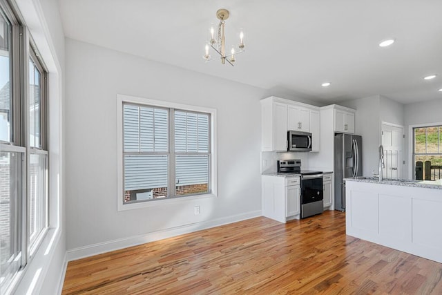 607 Westover Dr SW, Cleveland, TN 37311 - kitchen with stainless steel appliances, a chandelier, light wood finished floors, baseboards, and recessed lighting