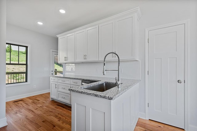 607 Westover Dr SW, Cleveland, TN 37311 - kitchen with a sink, white cabinets, light wood-style flooring, and recessed lighting