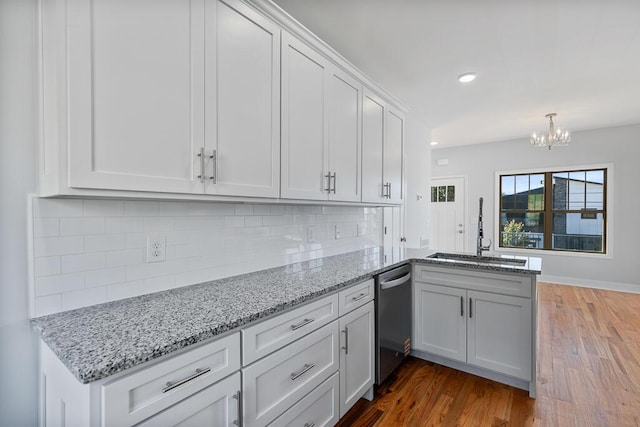 607 Westover Dr SW, Cleveland, TN 37311 - kitchen with dishwasher, a sink, wood finished floors, a chandelier, and a peninsula