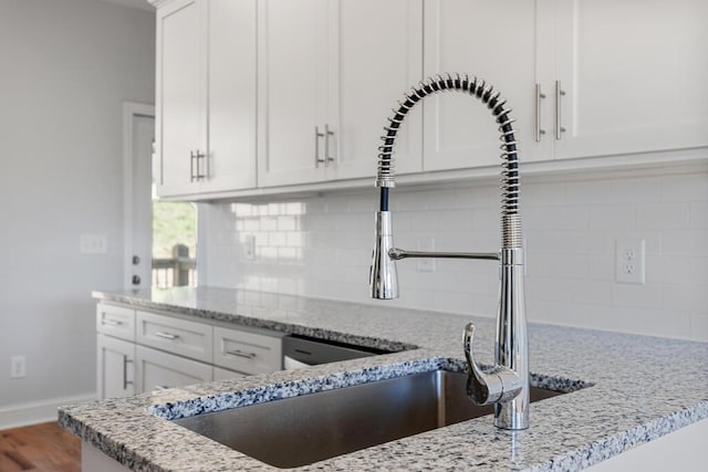 607 Westover Dr SW, Cleveland, TN 37311 - kitchen featuring backsplash, white cabinets, and light stone countertops