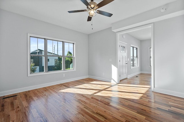 607 Westover Dr SW, Cleveland, TN 37311 - empty room featuring healthy amount of natural light, baseboards, wood finished floors, and a ceiling fan