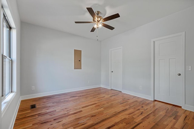 607 Westover Dr SW, Cleveland, TN 37311 - spare room with electric panel, light wood finished floors, ceiling fan, and baseboards