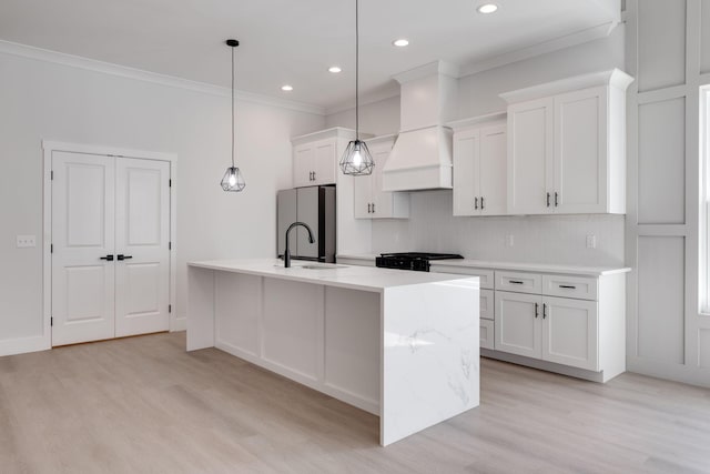 6221 Alexandra Pl, Chattanooga, TN 37416 - kitchen with freestanding refrigerator, a sink, crown molding, a center island with sink, and white cabinetry