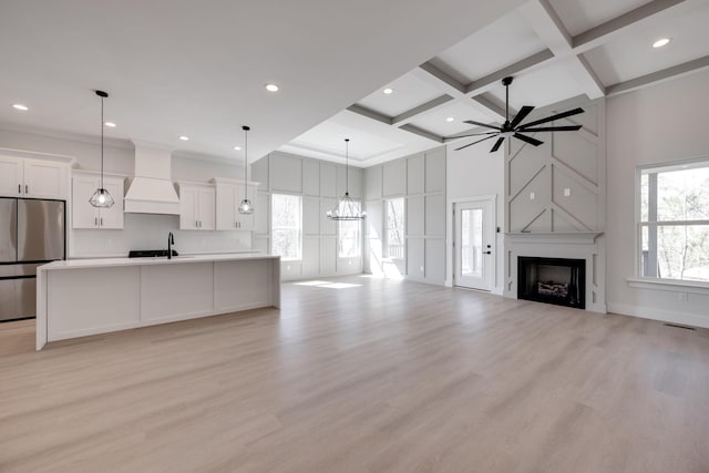 6221 Alexandra Pl, Chattanooga, TN 37416 - unfurnished living room with coffered ceiling, a sink, light wood-style flooring, a ceiling fan, and a large fireplace