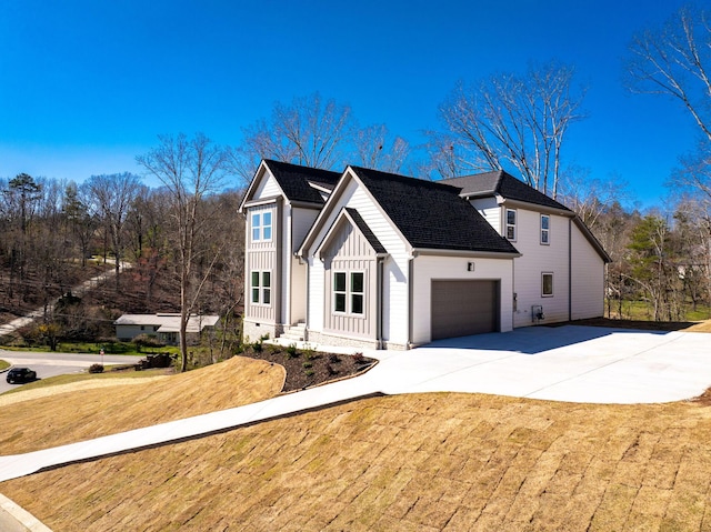 6221 Alexandra Pl, Chattanooga, TN 37416 - view of property exterior featuring board and batten siding, a garage, driveway, and a shingled roof