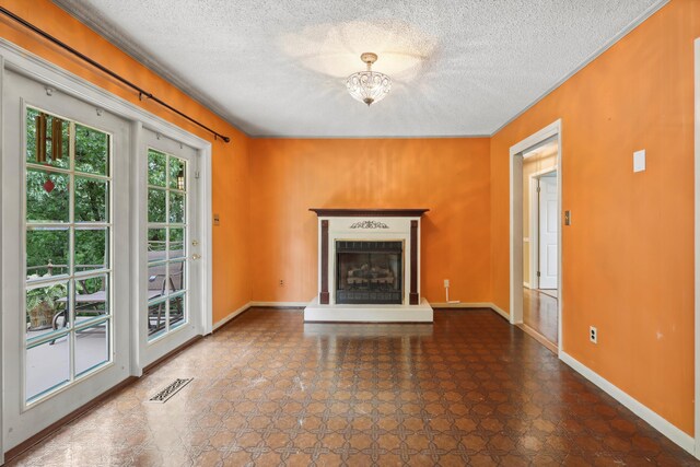 5839 Crestview Dr, Hixson, TN 37343 - unfurnished living room with a textured ceiling, a fireplace with raised hearth, baseboards, and ornamental molding