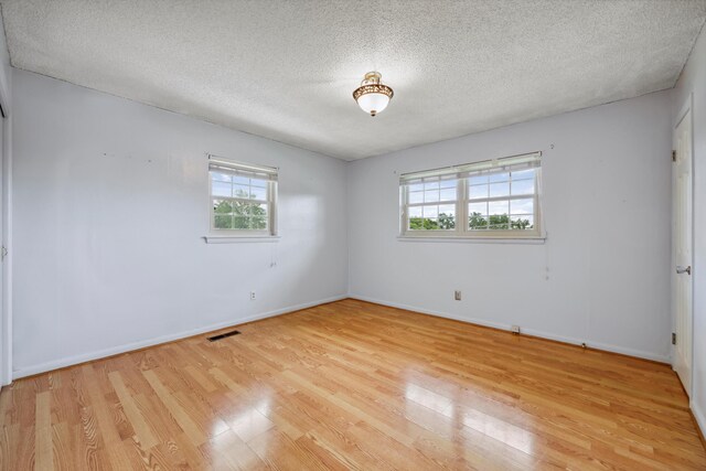 5839 Crestview Dr, Hixson, TN 37343 - spare room with plenty of natural light, light wood-type flooring, a textured ceiling, and baseboards