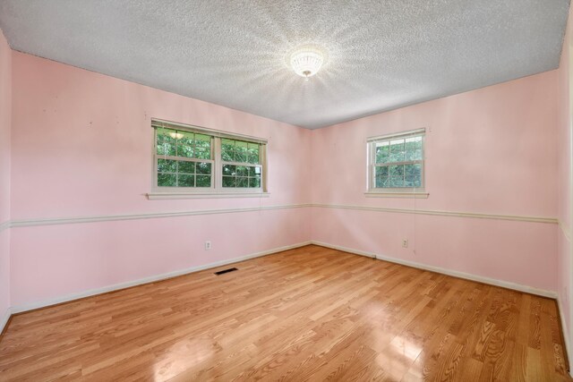 5839 Crestview Dr, Hixson, TN 37343 - empty room with wood finished floors, a textured ceiling, and baseboards