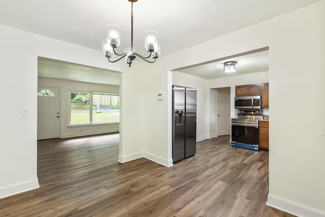 1331 Phils Dr, Chattanooga, TN 37421 - kitchen with stainless steel appliances, a chandelier, dark wood-type flooring, and baseboards